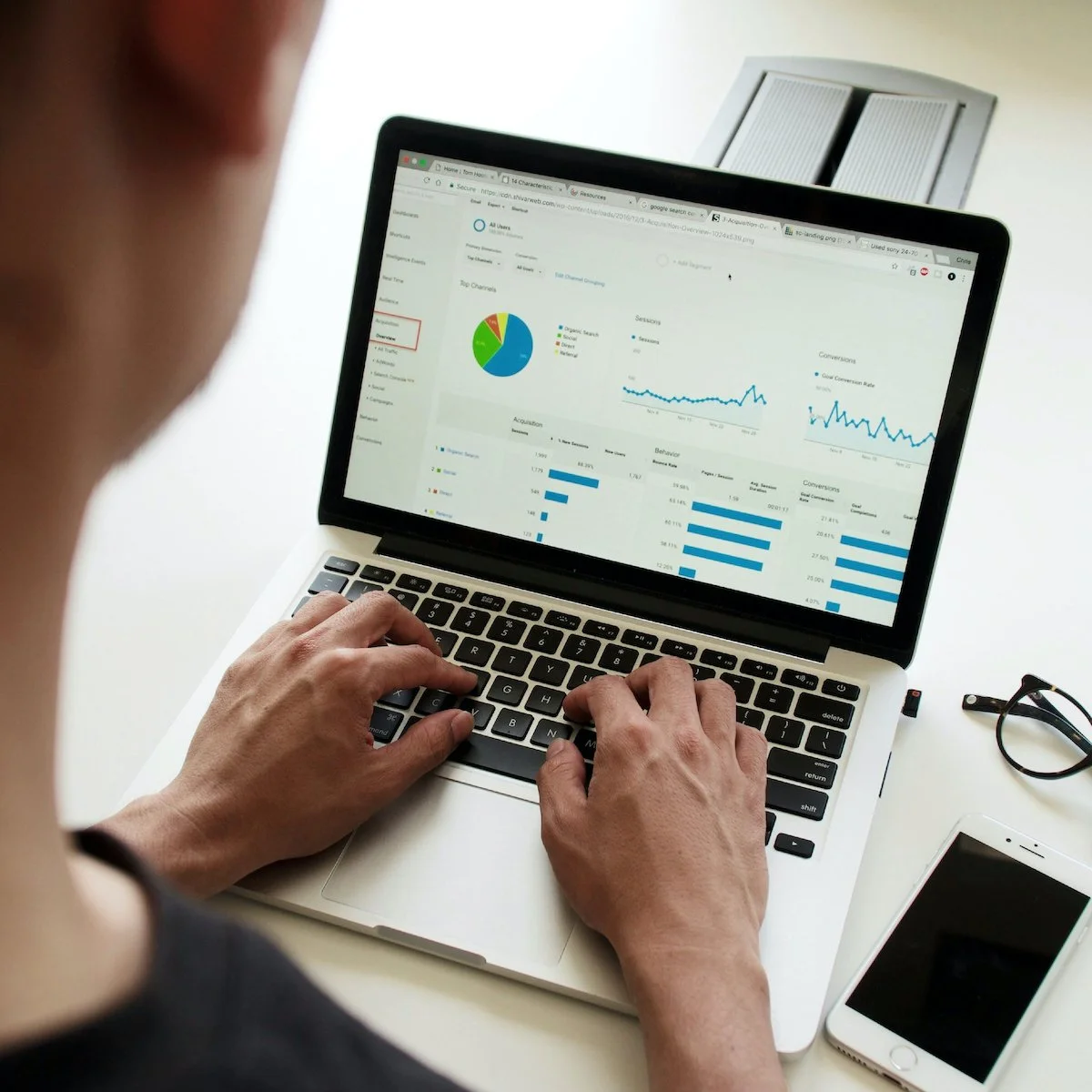 Person reviewing analytics dashboards on a laptop