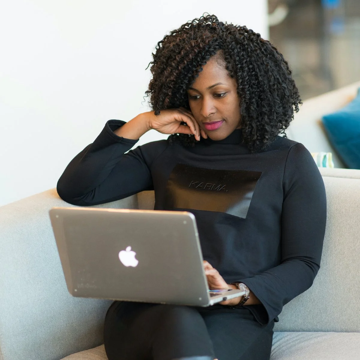 Professional working on a laptop in a bright lounge