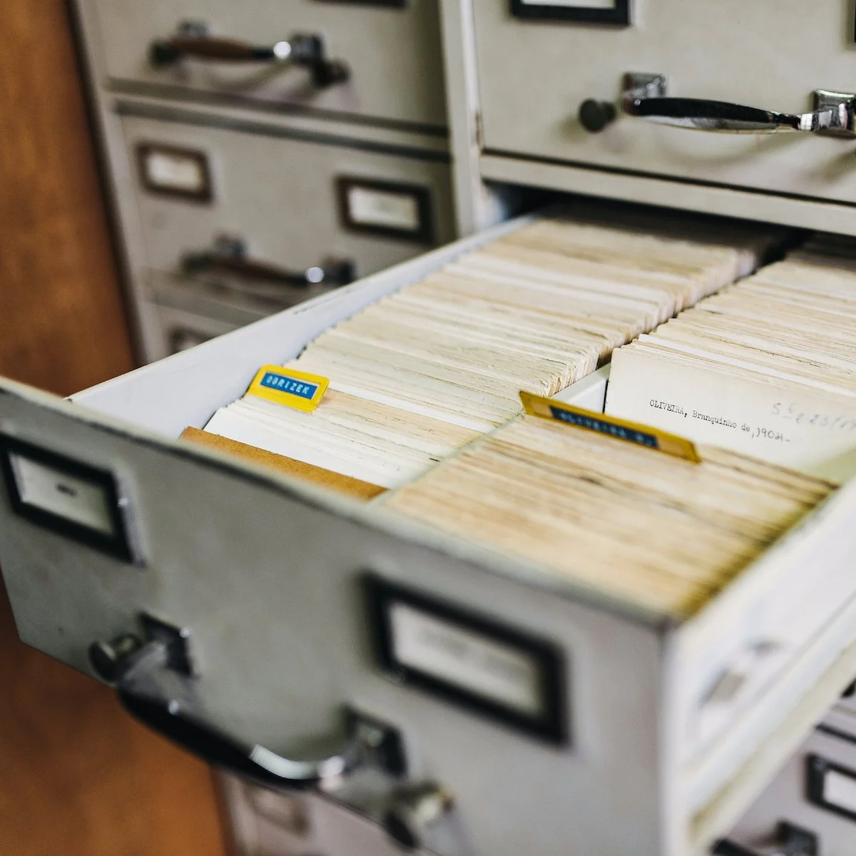 Open filing cabinet drawer full of paper records